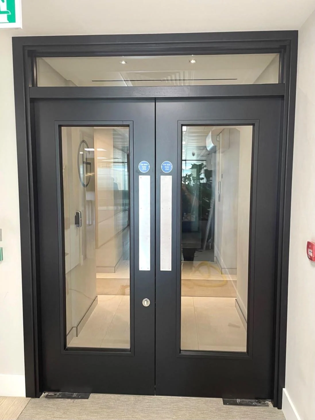 Glazed double fire doors with matching frame and metal push plates