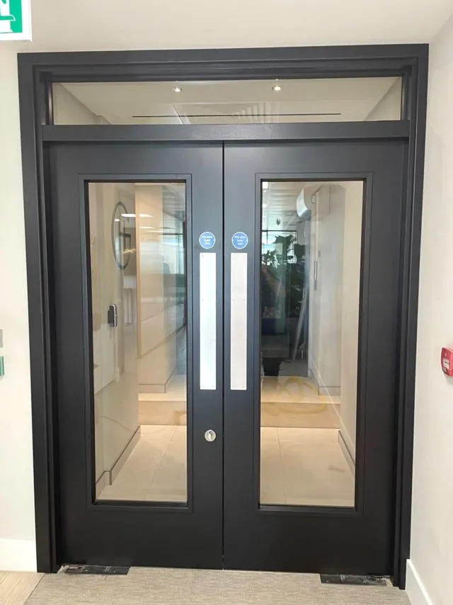 Charcoal double doors with glazed panels and a glazed panel above