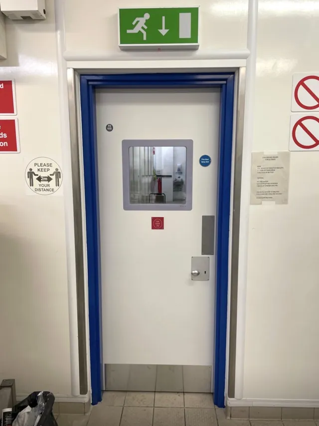 White single door with a glazed panel inside a blue frame